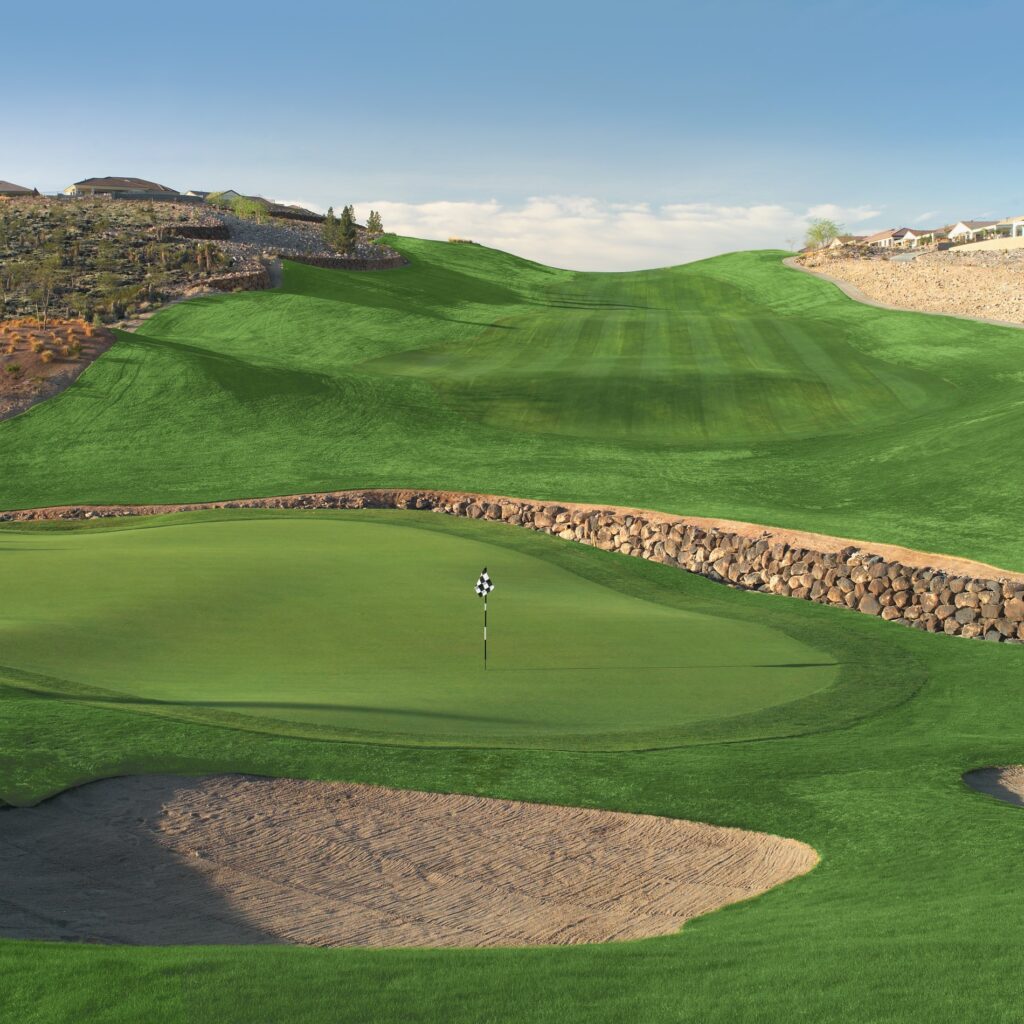 Bunker and green looking back into the fairway with a blue sky above